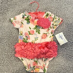 Boutique Floral Ruffle Baby Onesie with Coral Accents includes hanger